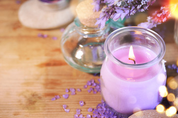 Obraz na płótnie Canvas lavender oil in a glass bottle on a background of fresh flowers. Aromatherapy.