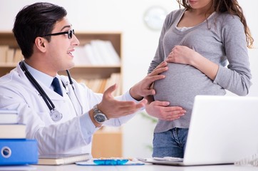 Fototapeta premium Pregnant woman visiting doctor for consultation