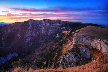 The tent stands on the edge of a cliff. Beautiful mountain landscape at sunset. Beautiful clouds, beautiful light.