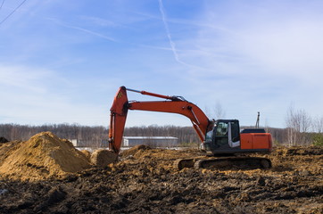 excavator digging a hole, landscape