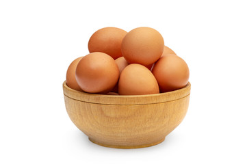 Wooden bowl with eggs on white.