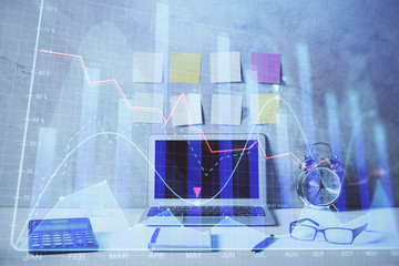Double exposure of forex graph and work space with computer. Concept of international online trading.