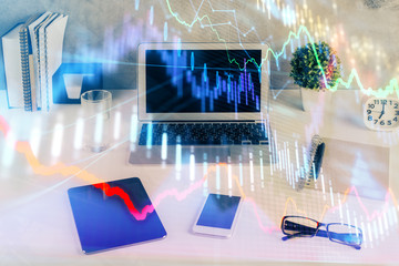 Forex market chart hologram and personal computer background. Double exposure. Concept of...