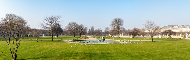 Panorama of the Tuileries Garden in Paris: View of a small pond in the empty garden in winter