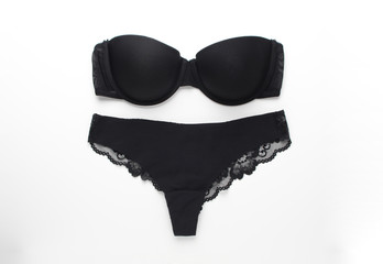 Set of black strapless bandeau bra and black panties . Balconette bra and women's underpants on...