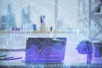 Stock market graph and table with computer background. Double exposure. Concept of financial analysis.