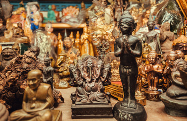 Ganesh statue, Buddha and many others figurines for sale in store of the Amulet Market