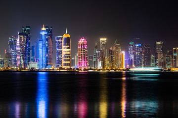 Obraz premium Vibrant Skyline of Doha at Night as seen from the opposite side of the capital city bay at night