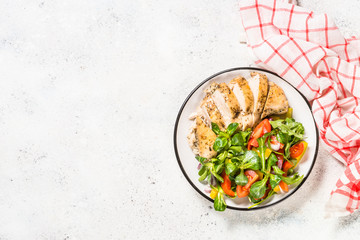 Baked chicken with fresh salad top view.