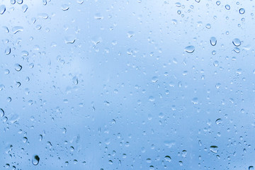 Water drops on glass or rain drop with blue filter