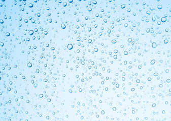 Fototapeta na wymiar Water drops on glass or rain drop with blue filter