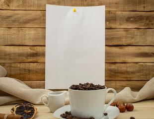 A4 paper sheet on clothespins with wooden background and coffee