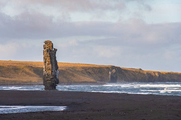 Hvitserkur rock formation in Iceland standing in stormy sea in front of black sand beach