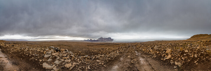 Langjokull Glacier behind huge muddy and rocky wasteland in the heart of iceland