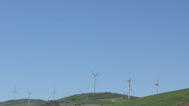 Landscape of wind turbines of renewable energy moving with blue sky a sunny day