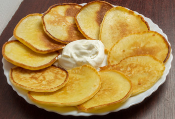 Homemade fritters with sour cream