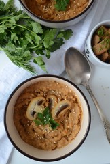 Photo of a lunch of lentil soup-puree with mushrooms, herbs and crackers.