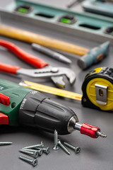 A screwdriver and other household tools for home repair. Studio shot, close-up.