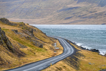 Fototapeta na wymiar Roadtrip in Iceland empty coast road curving along fjord