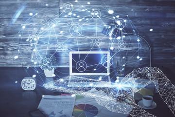 Computer on desktop with social network hologram. Multi exposure. Concept of international people connections.