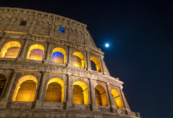 Roman Colosseum at Night under Full Moon and Starlight in Rome, Italy