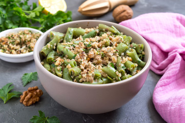 Salad with green beans and spicy walnut sauce in a bowl. Vegetarian, vegan menu.