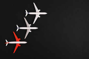 Obraz premium Three airplane models on a black background. place for inscription