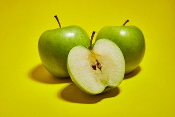 Green apple on yellow background. Flat lay, top view, copy space . Food dietary concept.