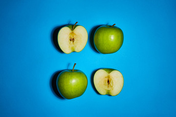 Green apple on blue background. Flat lay, top view, copy space . Food dietary concept.