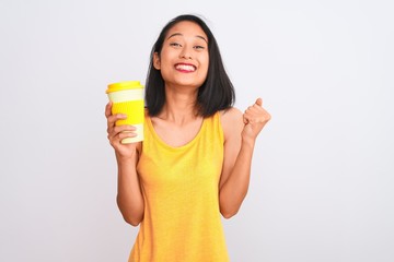 Young chinese woman drinking take away glass of coffee over isolated white background screaming proud and celebrating victory and success very excited, cheering emotion