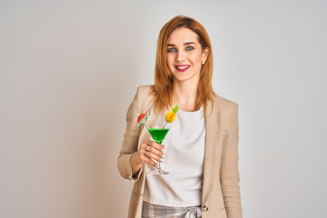 Redhead caucasian business woman drinking a summer cocktail over isolated background with a happy face standing and smiling with a confident smile showing teeth