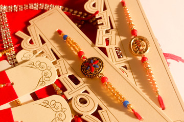 Indian festival Raksha Bandhan, rakhi on decorative plate. A traditional Indian wrist band which is a symbol of love between Brothers and Sisters