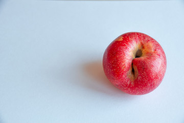 red ugly apple on white background