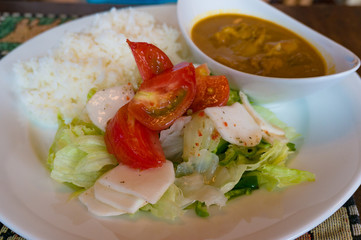 Rice with fresh vegetables and curry sauce