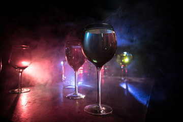 Goblet of white wine on wooden table on wooden wall background