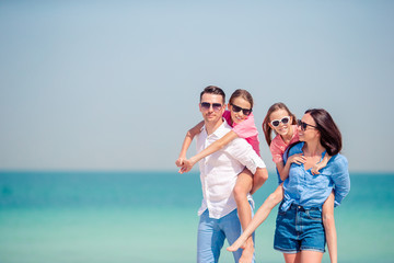 Fototapeta na wymiar Happy family with kids on the beach together