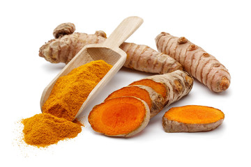 Fresh turmeric with slices and curcuma powder in a spoon isolated on white background