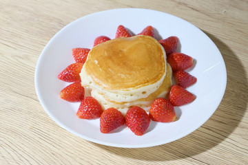 pancake and strawberry fruit sweet dessert food put on breakfast table
