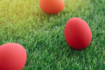 red easter egg on lawn green grass artificial, image of morning springtime concept