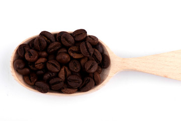 coffee beans in a spoon. tea in a spoon