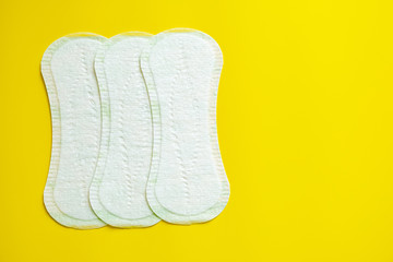 daily sanitary pad on a bright yellow background close-up of copy space