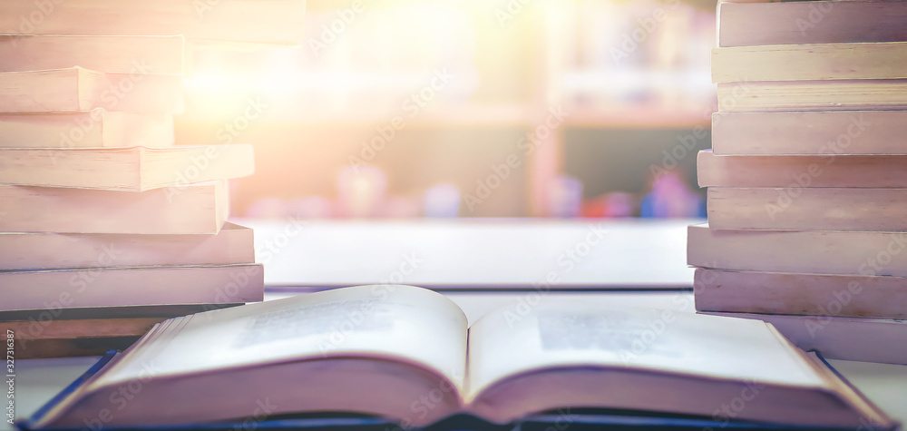 Poster stack of books in the library and blur bookshelf background
