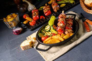Shish kebab with various vegetables and spice country potatoes