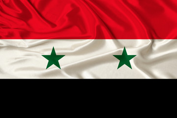 beautiful photograph of the national flag of Syria on delicate shiny silk with soft draperies, the concept of state power, country life, horizontal, close-up, copy space