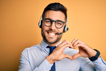 Young business operator man wearing customer service headset from call center smiling in love...
