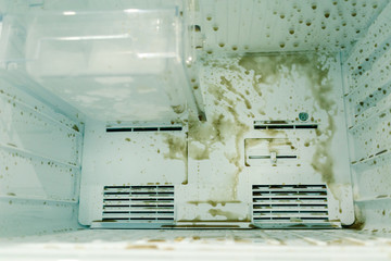 Fototapeta na wymiar dirty freezer of modern frigerator with splash of carbonated drink