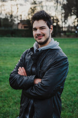 Portrait of a young millennial man in a park a summer afternoon