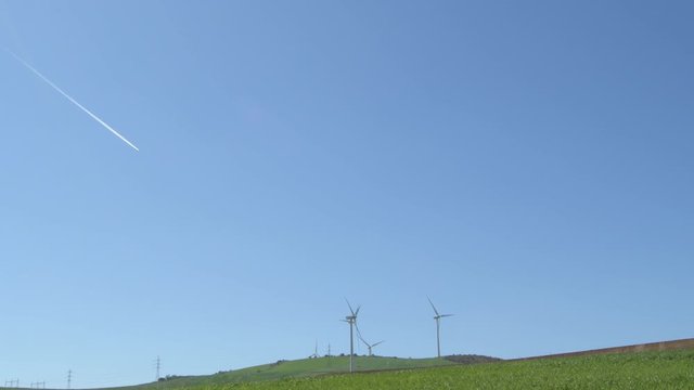 Wind turbines of renewable energy with jet reactor in blue sky a sunny day