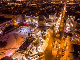 Fototapeta na wymiar Aerial city winter view with crossroads and roads, houses, buildings, parks. Helicopter drone shot. Wide Panoramic image. Kharkiv, Ukraine