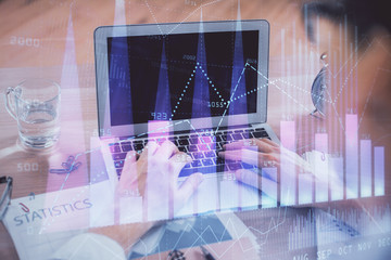 Multi exposure of forex graph with man working on computer on background. Concept of market analysis.